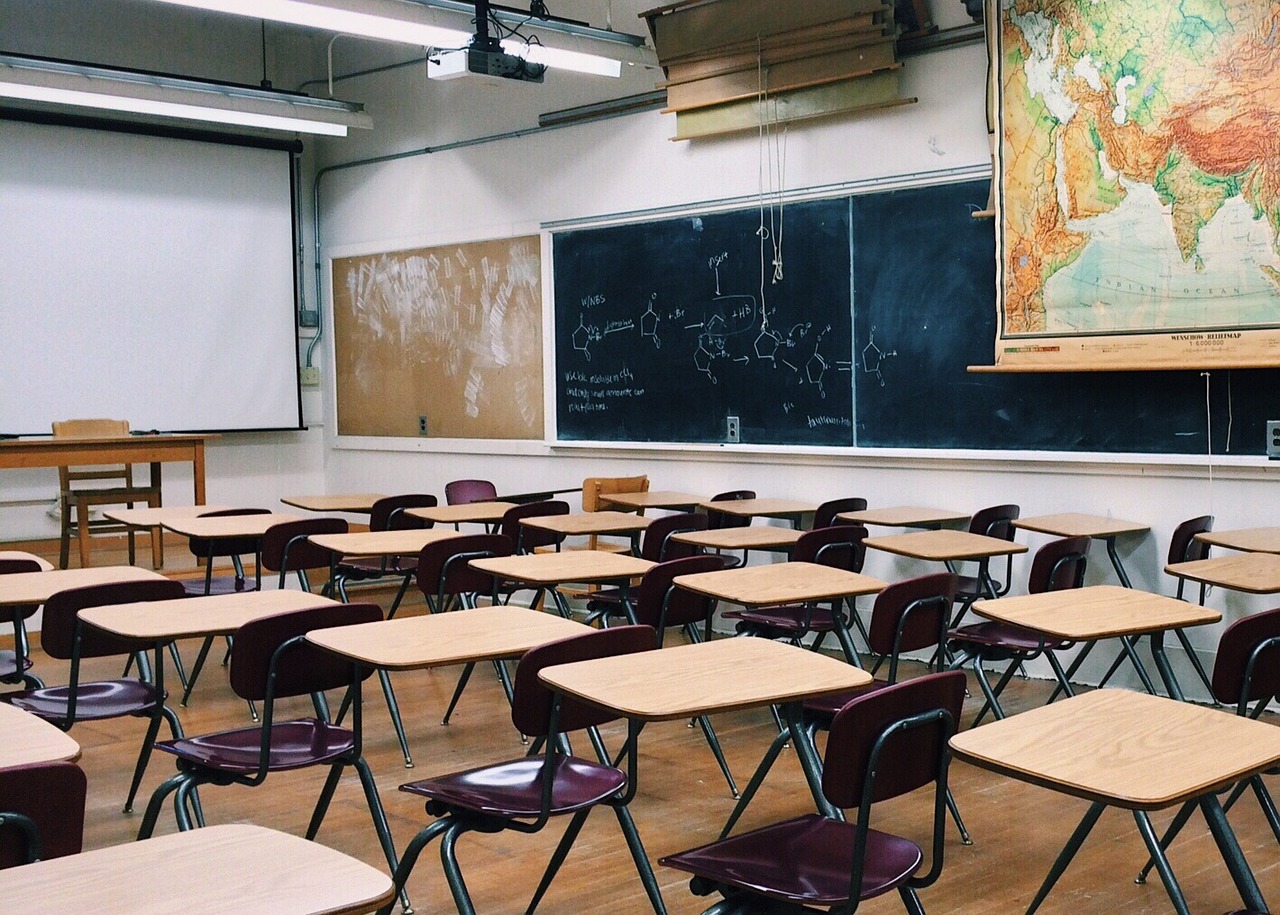 "Side-by-side comparison of a 1960s classroom and a modern classroom. The 1960s classroom features rows of wooden desks, a blackboard, and minimal technology, while the modern classroom showcases flexible seating, digital screens, and advanced learning tools."